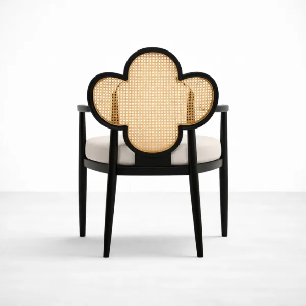 Back view of clover shaped cane back arm chair with black teakwood frame
