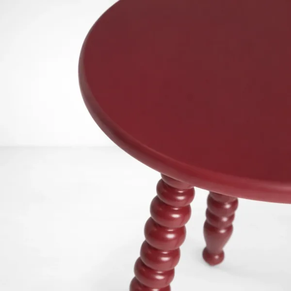 Handcrafted round teakwood side table with turned legs in ruby red finish by INTERIORZE