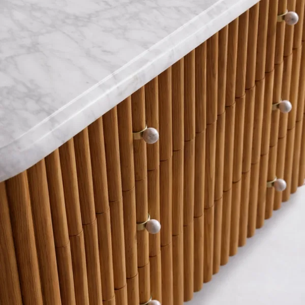 close-up of fluted drawer front and round knobs on INTERIORZE teak wood chest of drawers