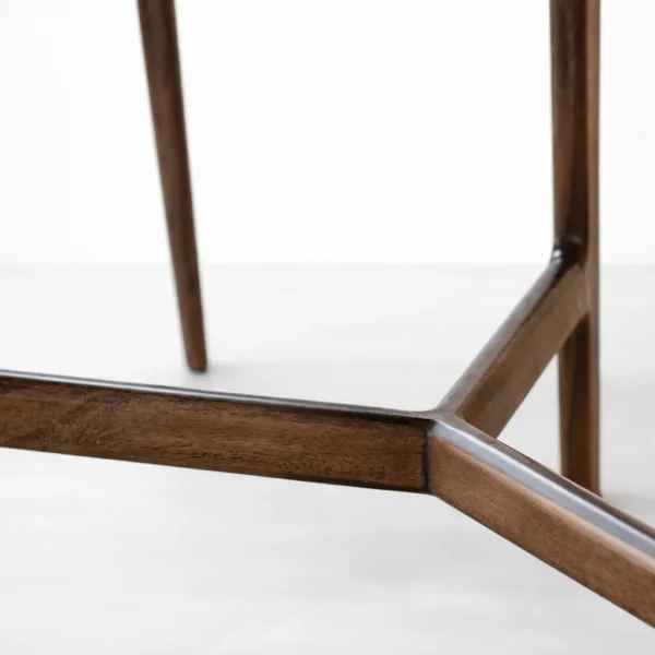 Close-up of wooden base detail on INTERIORZE Siena marble top round dining table