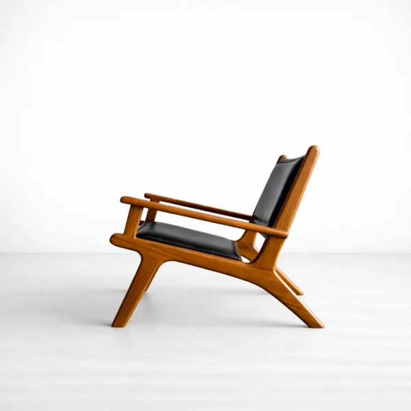 INTERIORZE Orion teakwood upholstered lounge arm chair with black seat and backrest in warm teak finish
