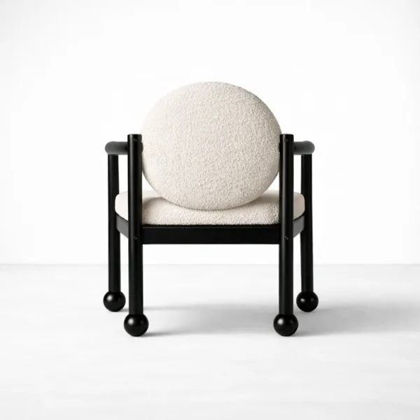 Front view of teakwood bouclé arm chair with cream upholstery and black polish