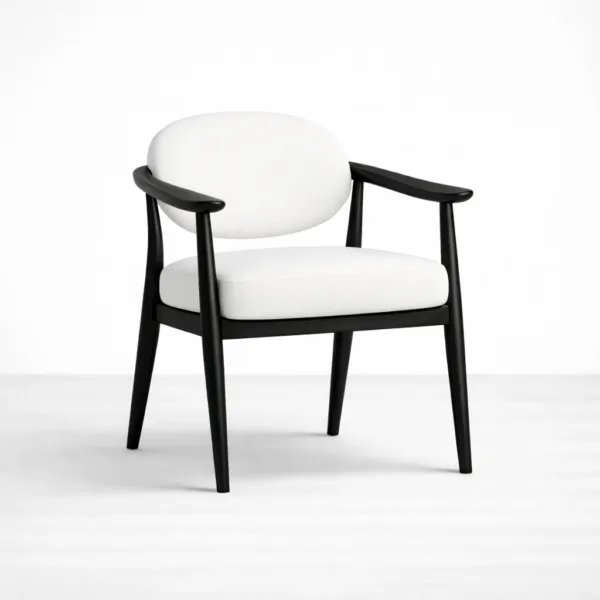 Angled view of black teakwood arm chair with white upholstered seat and back
