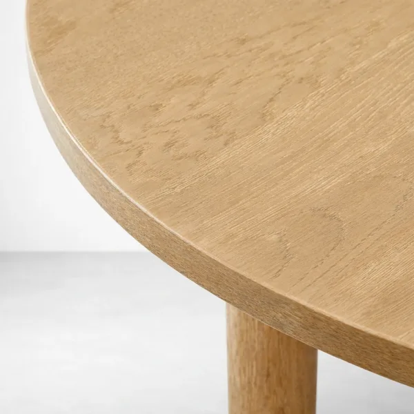 Close-up of round teakwood tabletop edge on INTERIORZE Orvyn dining table