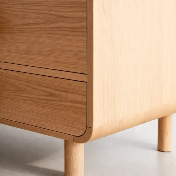 close up detail of rounded ash wood chest of drawers corner and side