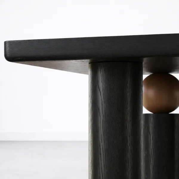 Close-up of contrast wood sphere accent on INTERIORZE Noir Axis solid wood dining table