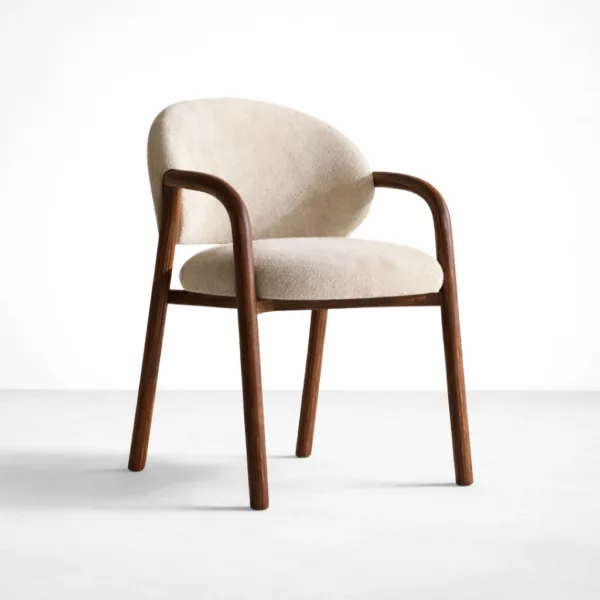 Angled view of teakwood arm chair with cream bouclé upholstery teakwood boucle arm chair