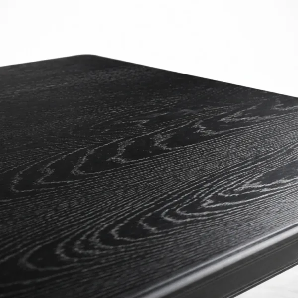 Close-up of black wood grain tabletop on INTERIORZE Noir Heritage dining table