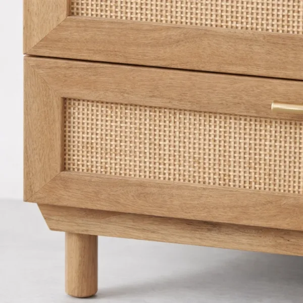 close-up of cane-front drawer detail on teak wood chest of drawers