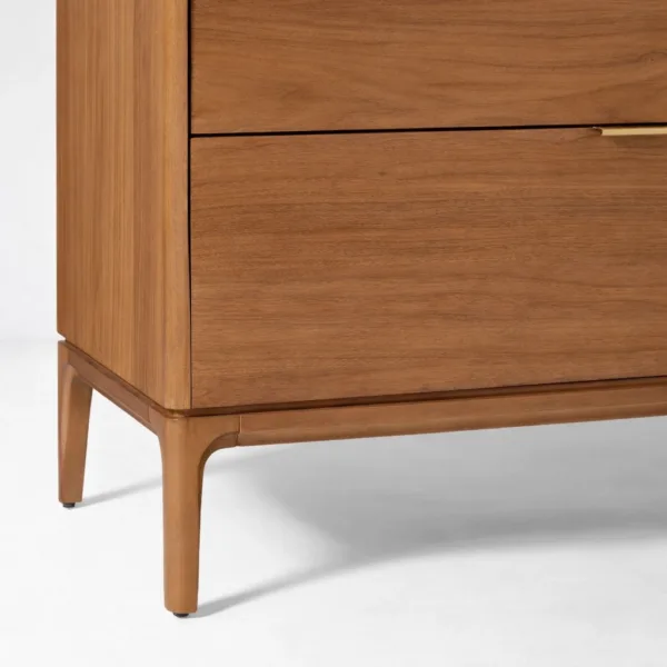 close-up view of INTERIORZE teak wood chest of drawers showing open top drawer and brass pull