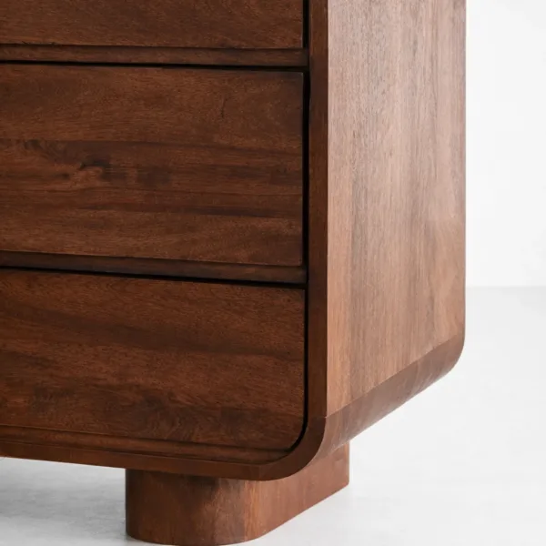 Corner detail highlighting the soft curved profile and teak wood grain