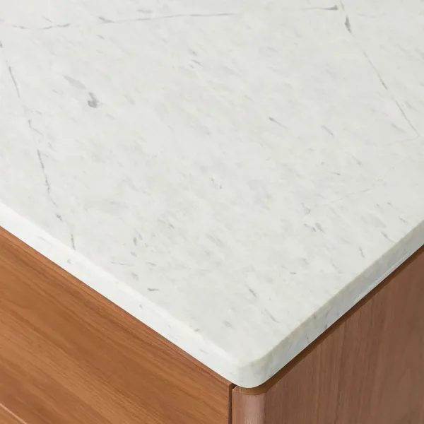 close-up of white marble top on INTERIORZE teak wood chest of drawers