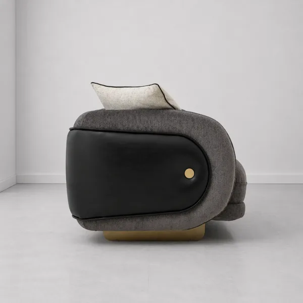 INTERIORZE charcoal designer sofa with black side panels and gold-toned base