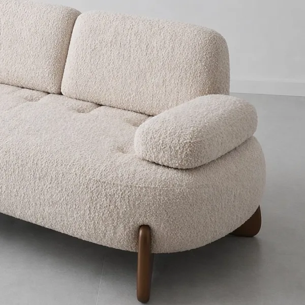 INTERIORZE cream boucle sofa with rounded shape and wooden legs