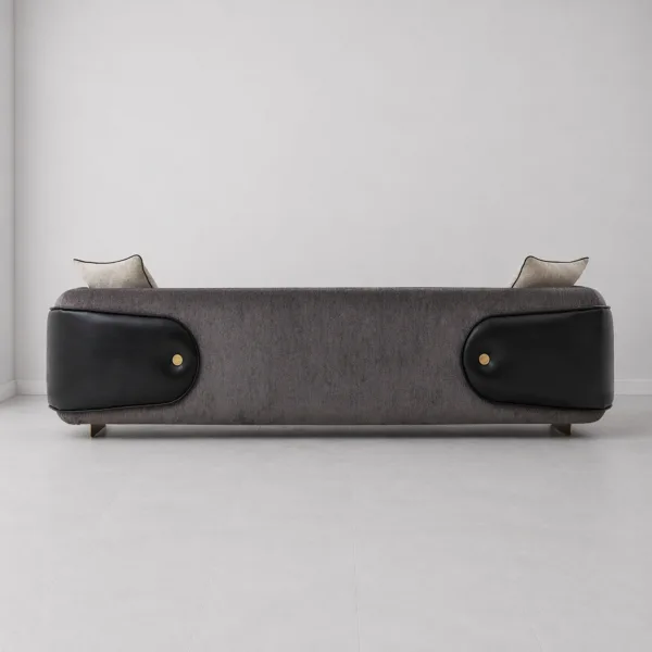 INTERIORZE charcoal designer sofa with black side panels and gold-toned base